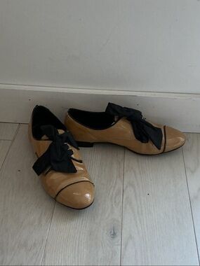 Prada Tan Patent Leather Flats with Black Bow Trim
